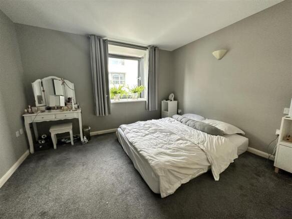 Bright, spacious bedroom with stylish vanity....