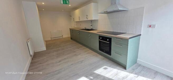Modern kitchen with sleek sage green cabinetry...
