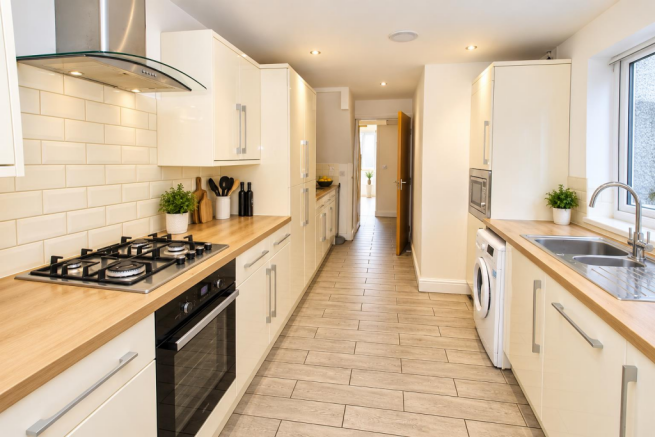 Modern Galley Kitchen with Warm Wood Accents.png