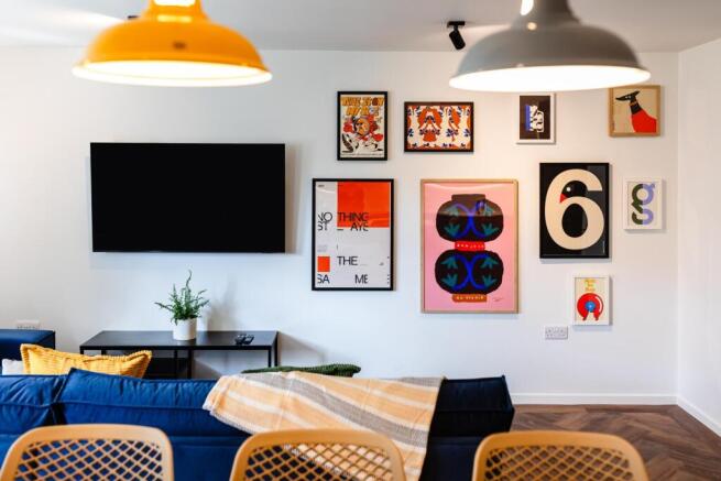 Bright, modern living room with a wall-mounted ...