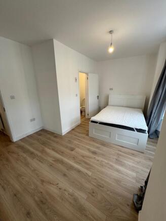 Spacious double bedroom featuring modern decor ...