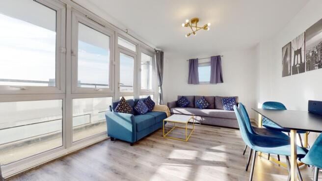 Bright, stylish lounge with floor-to-ceiling gl...