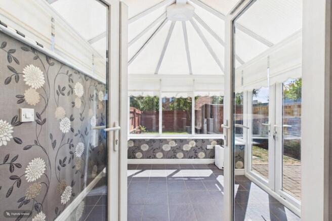 The conservatory with doors to the sunny south fac