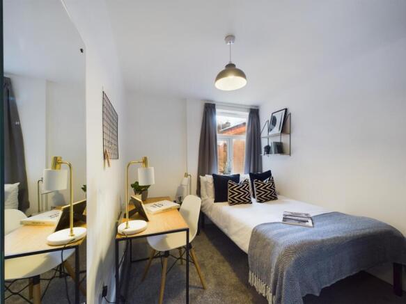 A bright and inviting double bedroom featuring ...