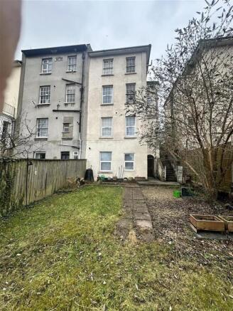 Spacious private rear lawn with path and trees...