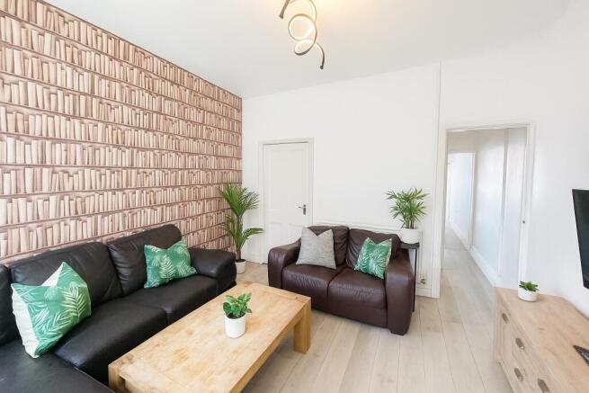 Stylish lounge with unique feature wall and sof...