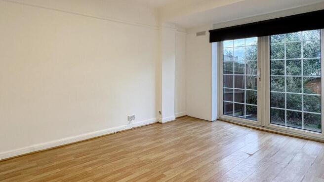 Bright, unfurnished living room with large floo...