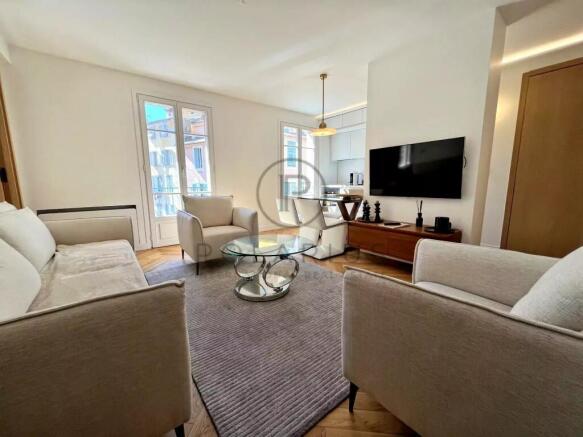 A modern, bright living room with beige sofas, a g