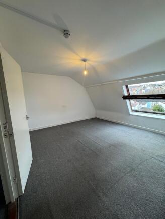 Bright top-floor double bedroom with a large sl...