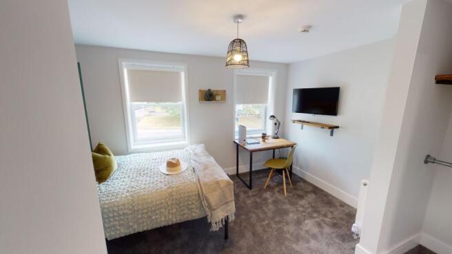 A bright and spacious living room with two larg...