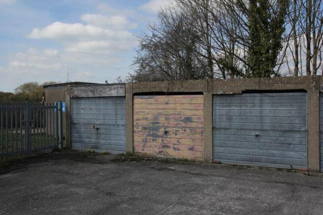 nearby garage (cream coloured door)
