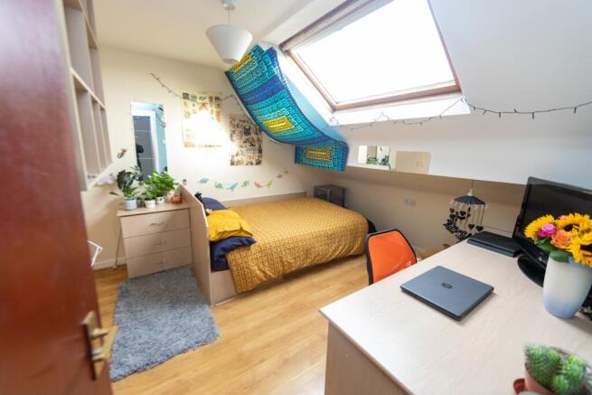 Bright and cozy double bedroom featuring vibran...