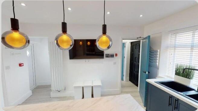 Bright and modern kitchen featuring large windo...