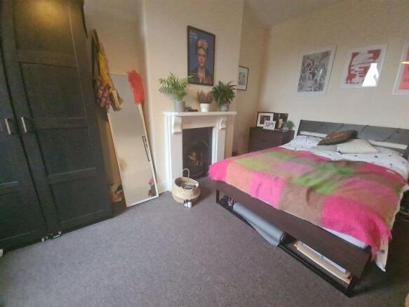 A cozy double bedroom featuring a neatly made b...