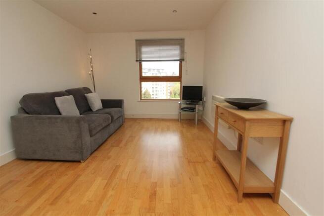 Bright lounge with sleek wood flooring...