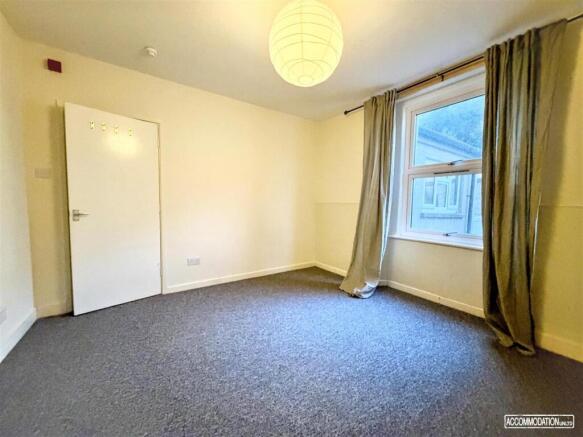 Spacious bedroom with window and clean carpet...