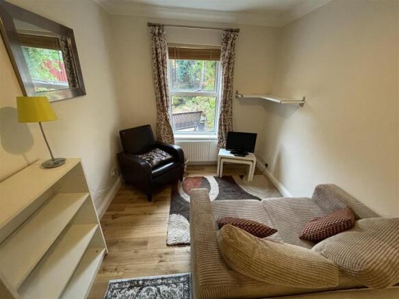 Cosy lounge with wood flooring and natural ligh...