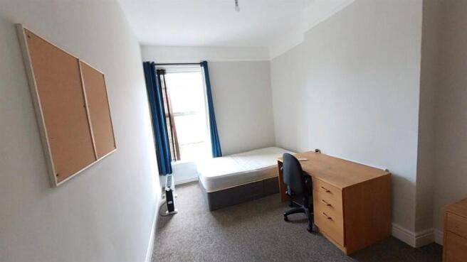 Bright bedroom with desk and natural light...