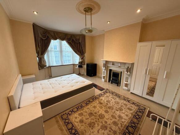 Bright master bedroom with elegant bay window...