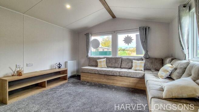 Spacious lounge with L-shaped seating and large wi