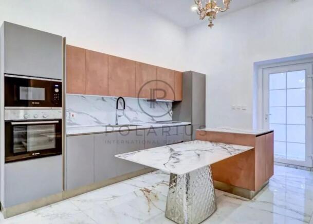 Modern kitchen with sleek cabinetry, marble counte