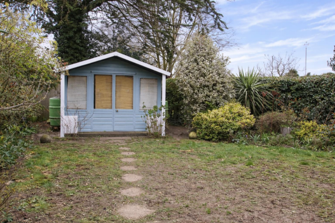 Serene garden with light blue summerhouse.png