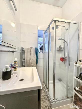 Bright modern shower with stylish white tiling...