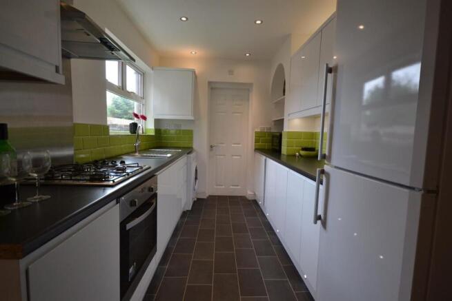 Modern kitchen with sleek white cabinetry...