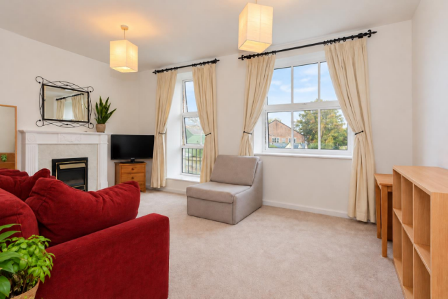 Bright Staged Living Room with Red Sofa.png