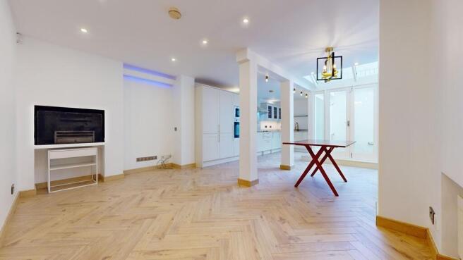 Bright open plan living space with wooden floor...