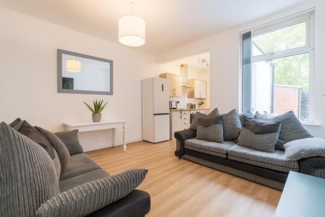 Bright, modern living room with large window, t...