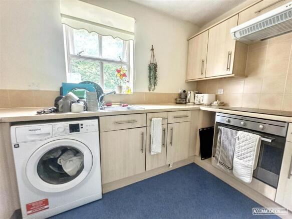 Bright kitchen with modern laundry facilities...