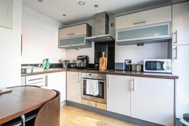 Modern kitchen with integrated oven and applian...