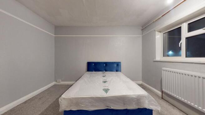 Bright and spacious double bedroom featuring a ...