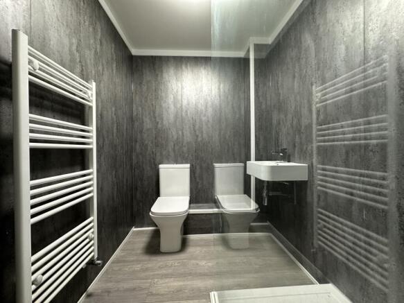 A modern and clean bathroom featuring a toilet,...