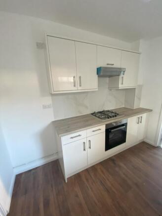A clean and modern kitchen with essential appli...