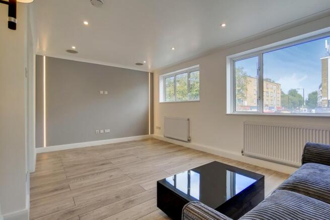 Bright modern lounge with sleek wood flooring...