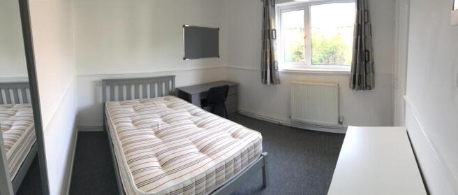 Bright, well-kept bedroom with a double bed, la...