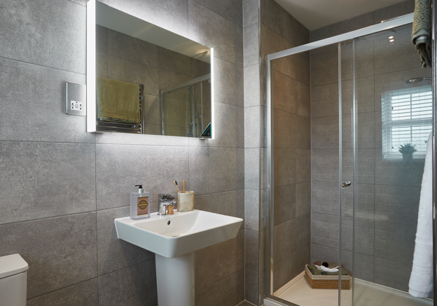 En-suite with fitted vanity unit and Porcelanosa tiles