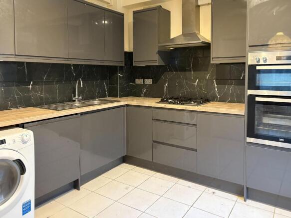 Sleek modern kitchen with stylish dark finish...