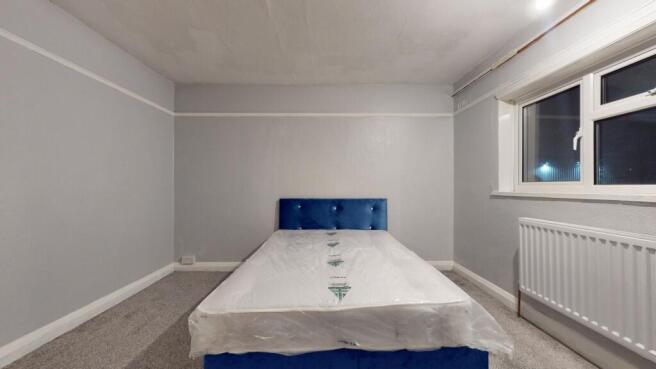 Bright, simply furnished double bedroom with a ...