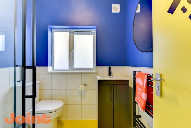 Bright, modern bathroom with bold blue walls, f...