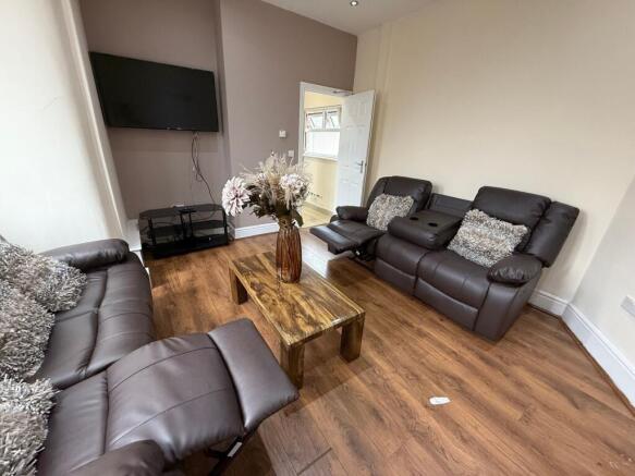 Well-presented living room with comfortable lea...