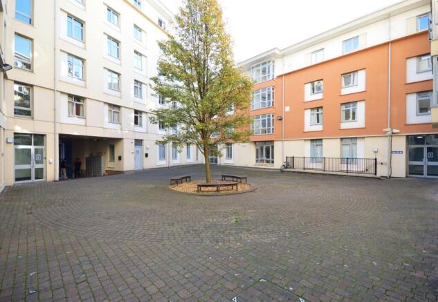 Bright central courtyard with seating and tree...