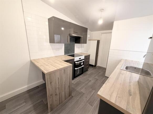Modern kitchen with sleek grey cabinets...