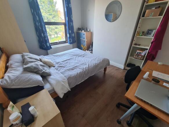 A bright and cozy double bedroom featuring a co...