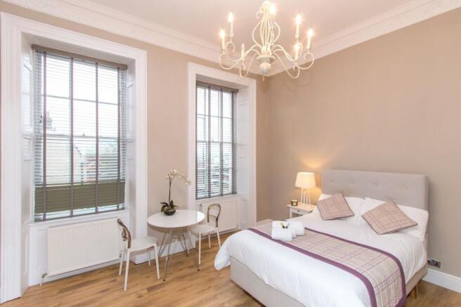 Bright, stylish double bedroom with a comfortab...