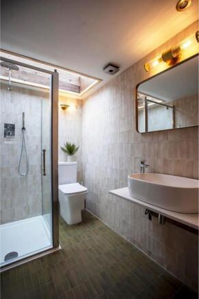 Modern bathroom with walk-in shower and sleek s...