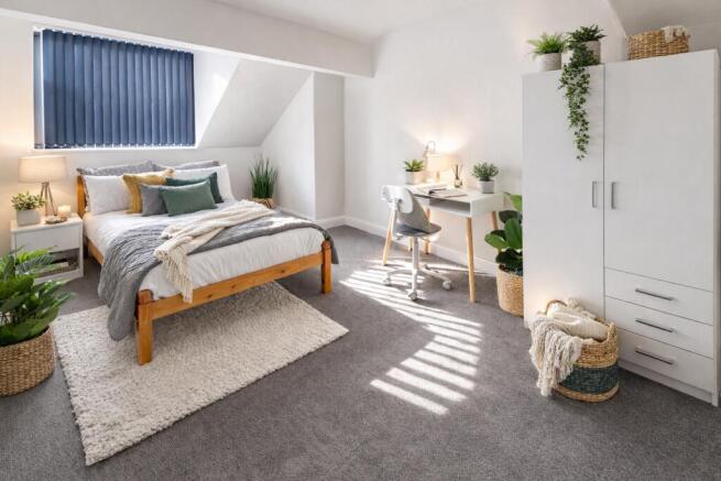 Bright master suite with desk and ample storage...