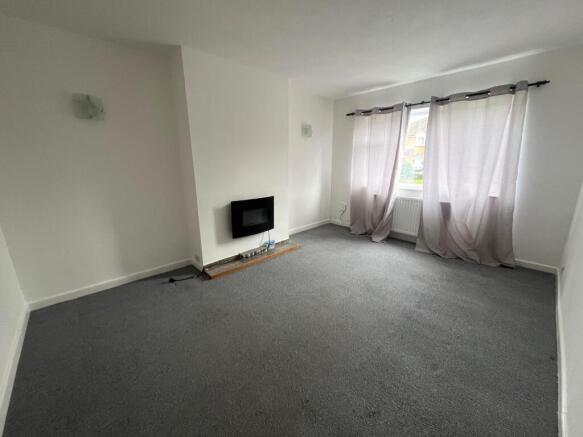 Bright, neutral living room with a large window...